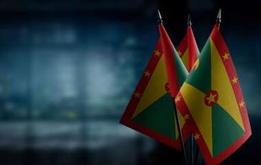 Small flags of the Grenada on an abstract blurry background