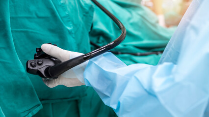 A doctor or surgeon in a light blue protective gown did a colonoscopy or gastroscopy inside...