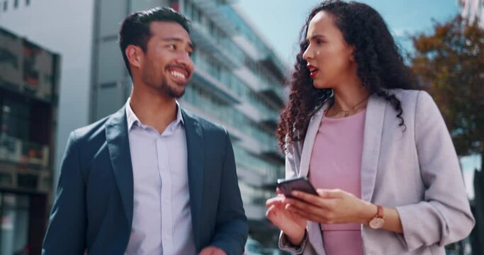 Business people, planning and walking before a meeting in a city with phone, briefing and sharing idea. Creative, partners and man with woman talking about proposal on commute in New York street