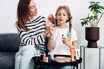 Mother and daughter wearing perfume
