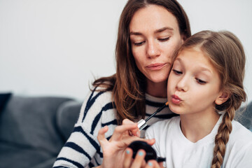 Mother and daughter do their own makeup