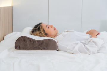 cute asian girl funny on bed with pillow