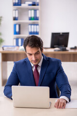 Young male employee working in the office