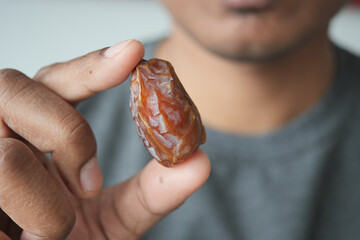 men holding a date fruit 