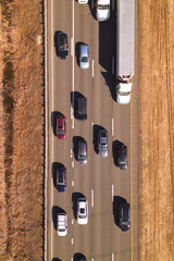 Slow traffic on interstate highway road.  Trucks and car on the road