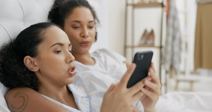 Phone, bed and couple of friends relax with social media post, mobile application or reading internet blog at home. Young gen z woman or lesbian people talking of lgbtq, planning or chat in bedroom