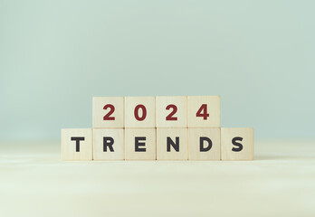 2024 trend concept. Wooden cube with 2024 and TRENDS text. Beautiful grey background, copy space. Used for banner in trend concept in new year for monitoring new business opportunities.