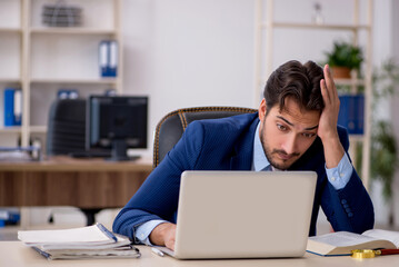 Young male employee working in the office