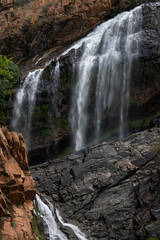 Fototapeta na wymiar Beautiful Waterfall at the Krugersdorp Botanical gardens. Beautiful nature with stunning water patterns and greenery showing the lush beauty as the water cascades