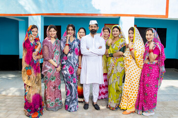 Fototapeta na wymiar Indian man politician standing along with group of traditional women. Concept of politics and social worker.