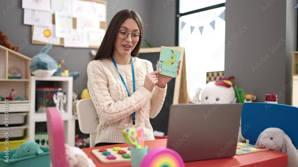 Sticker Young beautiful hispanic woman preschool teacher having online vocabulary lesson at kindergarten