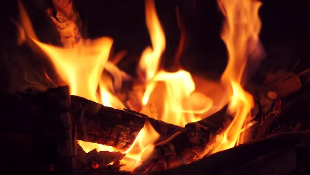 Beautiful footage of burning fire wood in the dark close up.