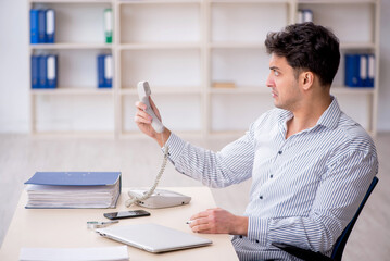 Young male employee working in the office