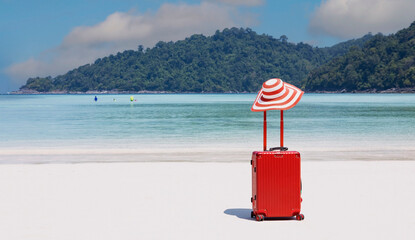 Red of the luggage on the beach- summer travel concept