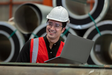 happy man engineer technical department using laptop working in power plant control panel of industry factory. male professional system electrician machine control with computer laptop.