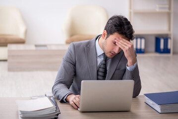 Young male employee working in the office