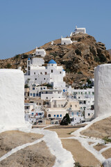 Panoramic view of a church,smaller chapels and the village overlooking the Aegean Sea in Ios in Greece,also known as Chora