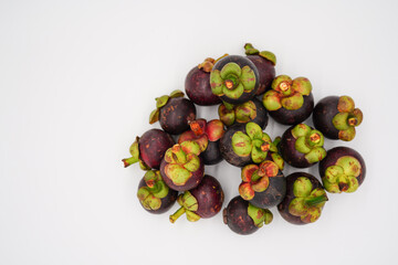 The fruit is named Mangosteen, famous as the Queen of Fruits. In Thailand, there are many for sale at affordable prices.