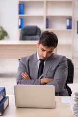 Young male employee working in the office