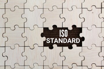 wooden puzzle with standard iso words. the concept of standardization. ISO quality control certification concept.