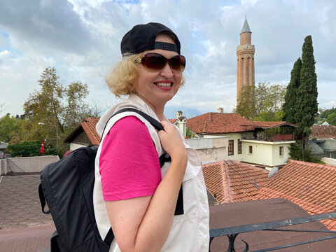 Senior adventure is ageless woman with backpack walking on old city of Antalya Turkey. Summer active tourism for pensioner...Senior adventure is ageless woman with backpack walking on old city of Anta