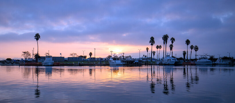Purple sunrise pink sky over Channel Islands harbor in Port Hueneme on the gold coast of California United States