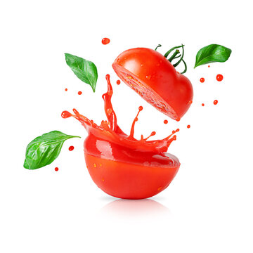 Splashing tomato juice with flying basil leaves isolated on white background. Design element for product label.