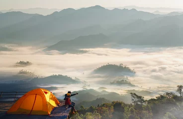 Vlies Fototapete Camping Asian couple enjoy in they tent at they camping point with morning sunrise view