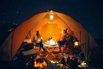 Fototapete Camping Asian couple enjoy in they tent in camping trip on night time