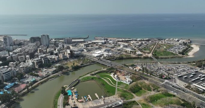 Aerial footage of the Tel Aviv Port Promenade with the Tel Aviv Ramat Gan skyline in the background. Filmed in C4K Apple ProRes 422 HQ