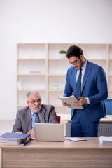 Two male colleagues working in the office