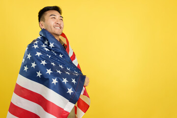 Proud chinese man wrapping with a USA national flag