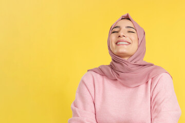 Fototapeta premium Happy muslim woman laughing with eyes closed