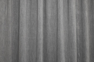 Beautiful simple gray curtain with folds ripples background. Heavy grey drape window cover interior...