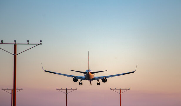 Airplane landing during sunset