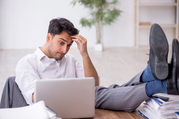 Young male employee working in the office