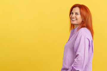 Happy redheaded mature woman smiling at the camera