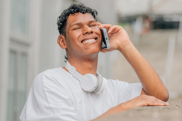 young latino man on the street talking on the mobile phone