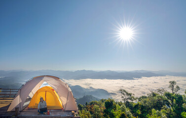 Asian business woman working with her computer between her camping tent trip