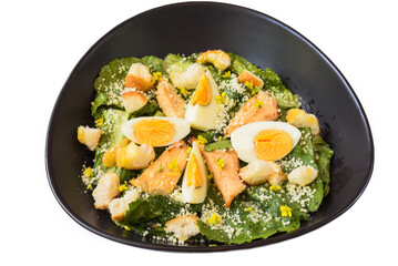 Caesar salad served in Vietnamese style on black background