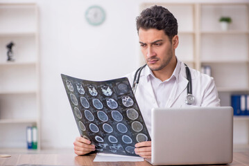 Young male doctor radiologist working in the clinic