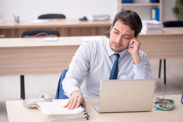 Young male employee working in the office