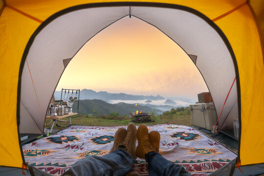 Asian couple sweet in tent in camping with moutain background