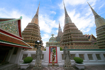 Asian travellert woman walking in Pagoda area in Wat Pho near Thailand grand palace and wat phra...
