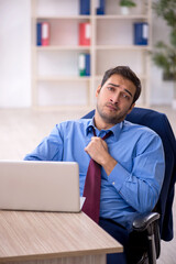 Young male employee and too much work in the office