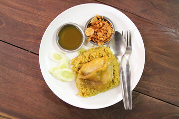 Chicken Biryani is one of the most popular dishes among Muslims. put on a wooden brown table