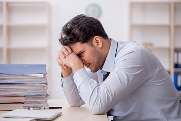 Fototapeta premium Young male employee working in the office