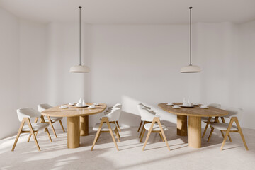 White cafe interior with two wooden tables and seats on light concrete floor