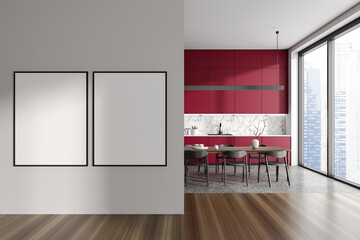 Red and white kitchen with dining table and posters