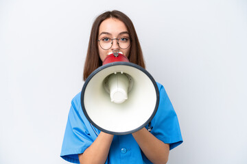Young nurse Ukrainian woman isolated on white background shouting through a megaphone